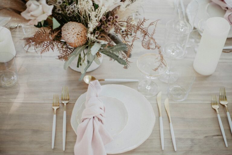 place setting with pink dishes and matching pink and gold cutlery