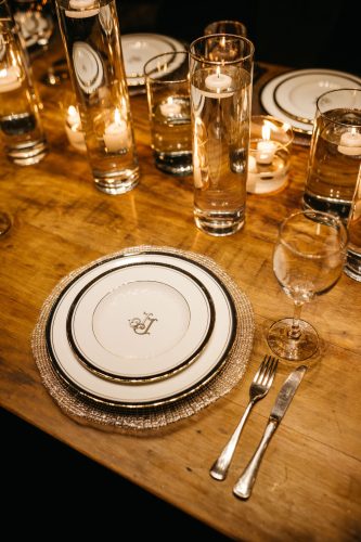Luxury place setting with candles, glassware and fine china for an intimate dining experience.